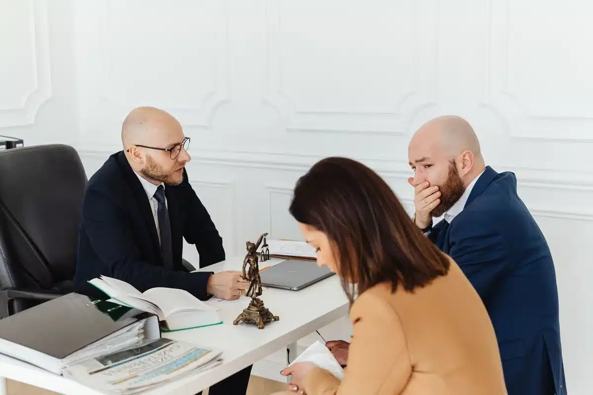 Séance de médiation entre deux parties avec un médiateur neutre facilitant le dialogue