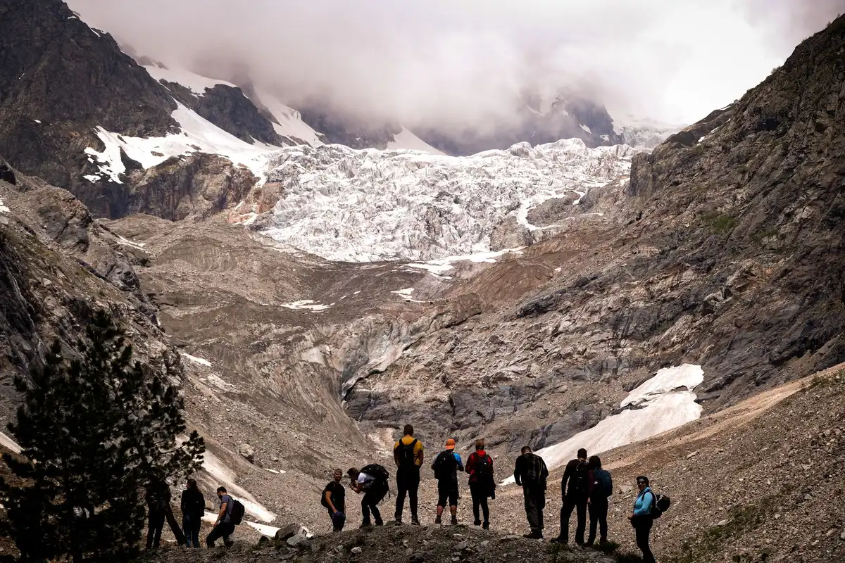 Groupe de jeunes randonneurs marchant ensemble sur un sentier en montagne